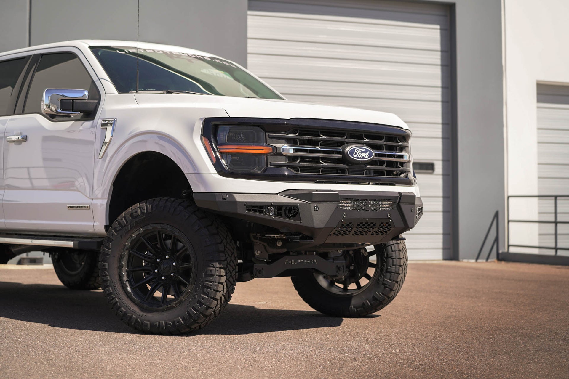 A low-profile 2024 Ford F-150 HoneyBadger Front Bumper installed outside